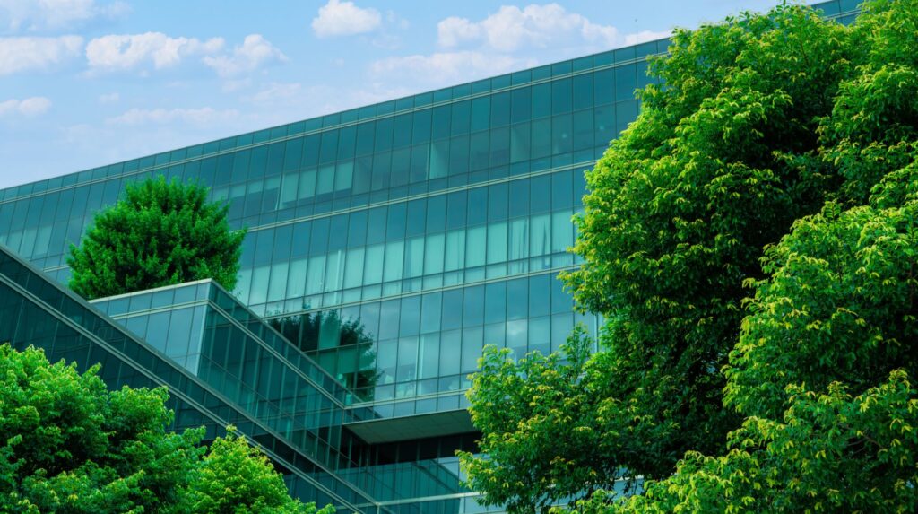 Energy-efficient glass facade with Low-E insulating glass units surrounded by green trees
