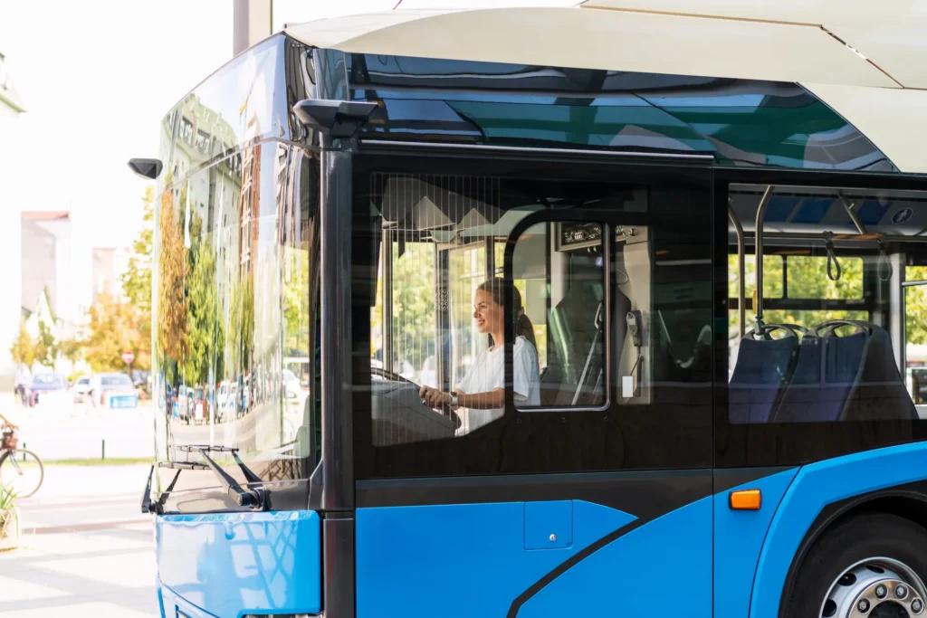 City bus with automotive windshield glass
